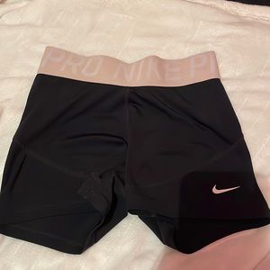 Black Nike pros with pink band